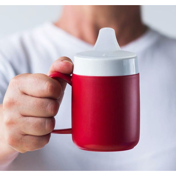 Ornamin Spouted Large Opening Drinking Lid attached to a beaker