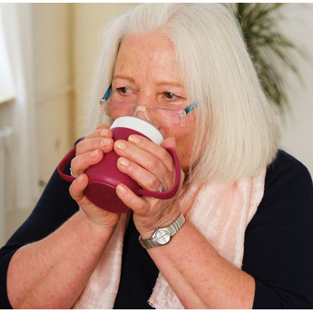 Woman drinking out of two handed mug