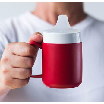 Ornamin Spouted Small Opening Drinking Lid demonstrated on red beaker