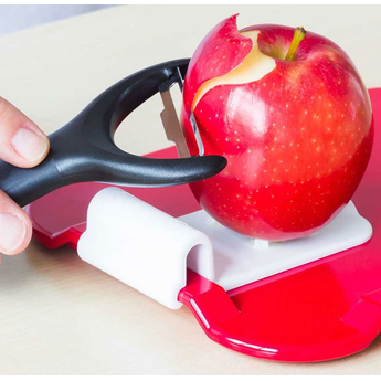 Food Prep Aid for Ornamin Non Slip Boards being demonstrated with an apple